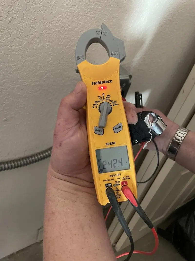 Voltage testing with clamp meter during Electrical Installation Services in Maplewood